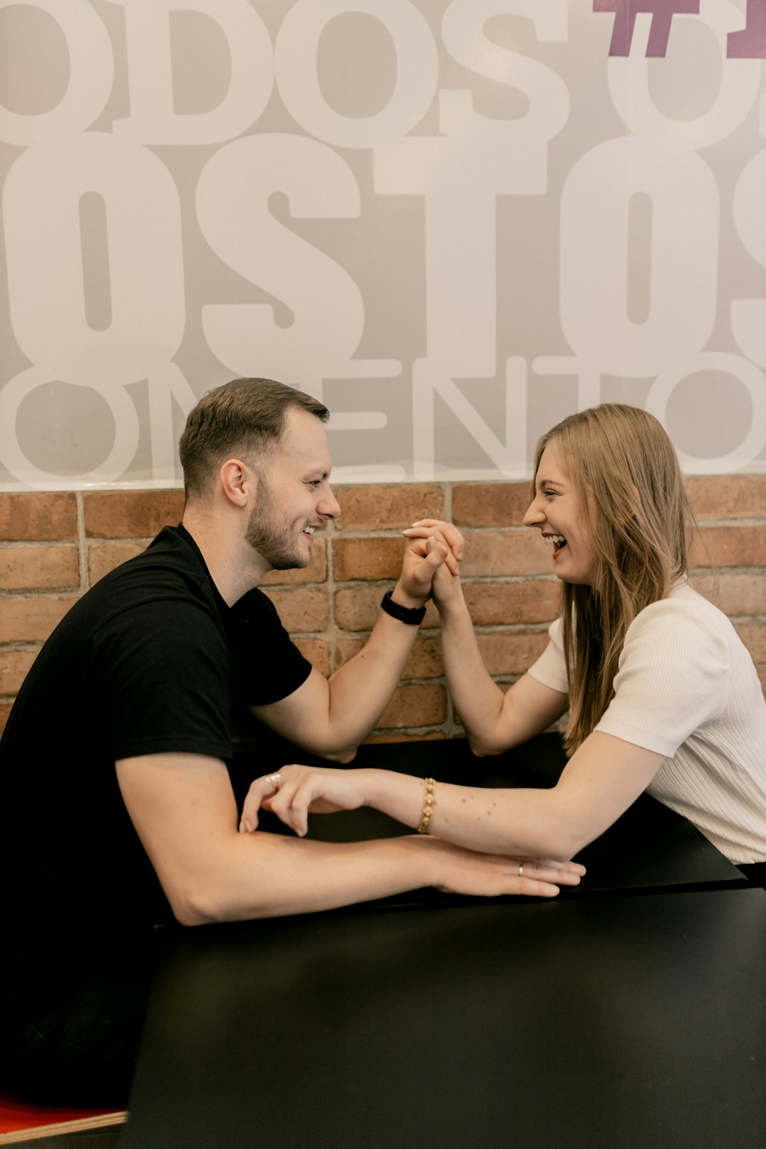a-man-and-a-woman-sitting-at-a-table-tkbsq5u072i