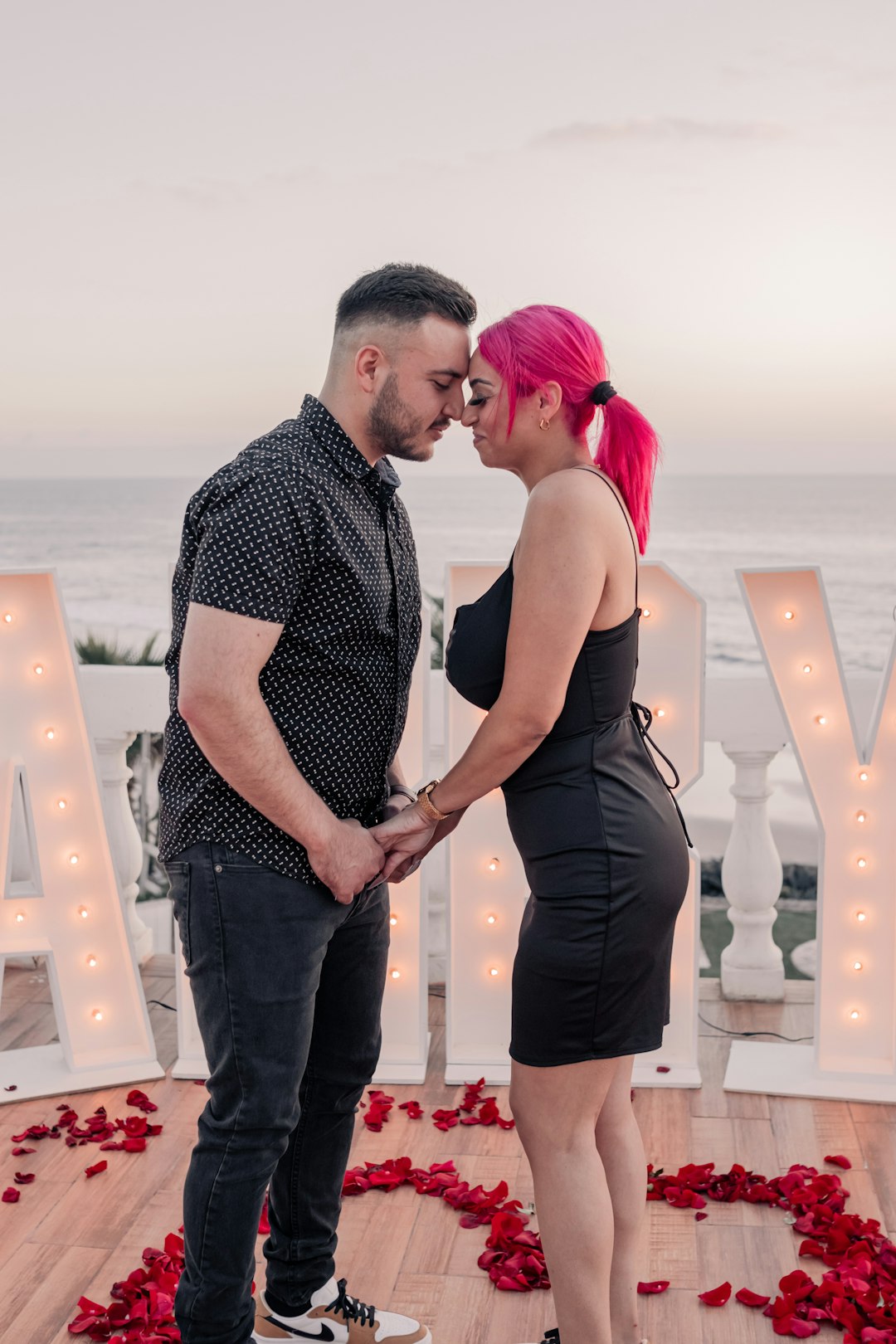 a-man-and-a-woman-standing-next-to-each-other-k06bdyzcuhi